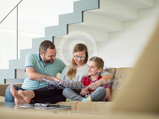 happy young family with little boy enjoys in the modern living room of their luxury home villa happy young family with little boy enjoys in the modern living room of their luxury home villa
