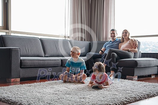 Happy Young Family Playing Together at home Happy Young Family Playing Together at home