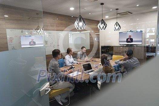 start up business people group attending videoconference call with senior investitior at modern office start up business people group attending videoconference call with senior investitior at modern office