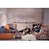group of young casual software developer sleeping on  sofa during a work break in creative startup office