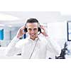 young smiling male call centre operator doing his job with a headset