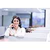 young smiling female call centre operator doing her job with a headset