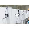 Headphones hanging on cubicle partition in empty call center office