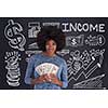 Portrait of a beautiful smiling afro american woman holding money isolated on a gray background