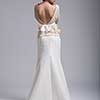 Rear view of a beautiful young bride in a wedding dress isolated on a white background
