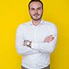 portrait of a handsome young man isolated over a yellow background