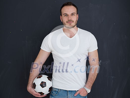 young handsome man playing with soccer ball isolated over grey background young handsome man playing with soccer ball isolated over grey background