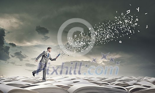 Young businessman running with book in hand Young businessman running with book in hand