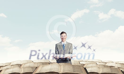 Young smiling businessman with opend book in hands Young smiling businessman with opend book in hands