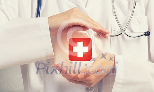 Close up of doctor hands with medicine cross sign Close up of doctor hands with medicine cross sign