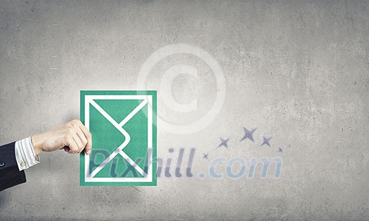 Hand holding envelope card representing email concept Hand holding envelope card representing email concept