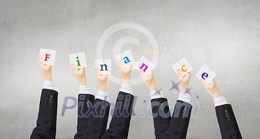 Group of business people holding in hands cards with letters Group of business people holding in hands cards with letters