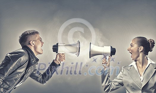 Furious woman screaming agressively in megaphone at man Furious woman screaming agressively in megaphone at man