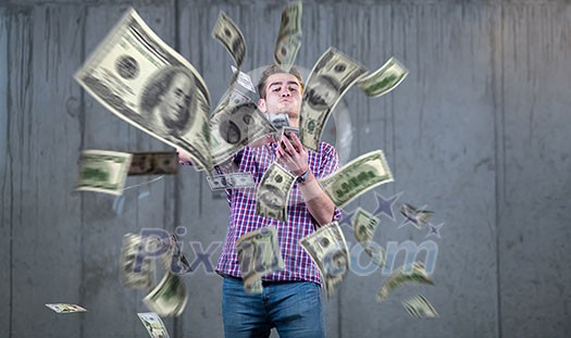 business, people and finances concept Happy young businessman throwing US dollar banknotes and enjoying while making the rain of money in new startup office business, people and finances concept Happy young businessman throwing US dollar banknotes and enjoying while making the rain of money in new startup office