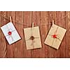 Envelopes hanging on rope on wooden background
