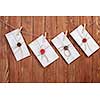 Envelopes hanging on rope on wooden background