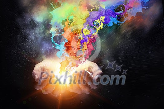 Close up of hand holding splashes of colorful paint Close up of hand holding splashes of colorful paint