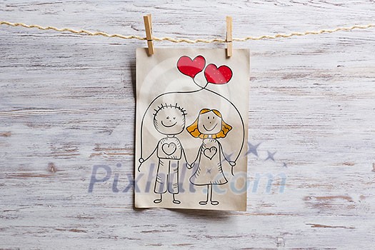 Paper sheet with sketches hanging on rope. Mixed media Paper sheet with sketches hanging on rope. Mixed media