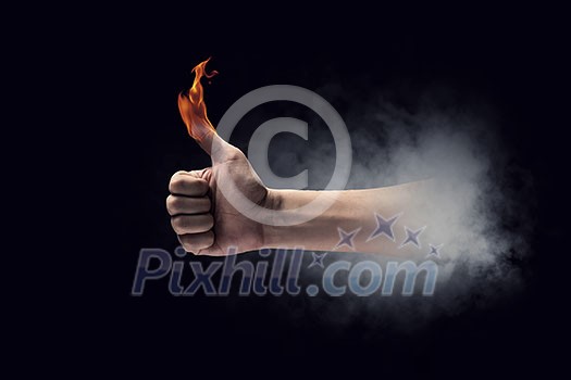 Young businessman holding fire flames in palm Young businessman holding fire flames in palm