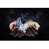 Close of person hands holding water splashes