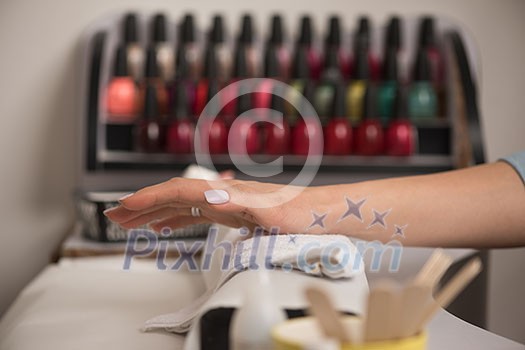 Beautiful fingers with french manicure on the towel. Manicure in a beauty salon.