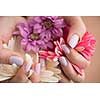 beauty delicate woman hands with manicure holding flower close up