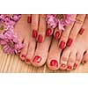 Closeup photo of a female feet and hands at spa salon on pedicure and manicure procedure