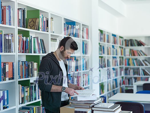 portrait of student in collage school library, arab youth learning and reading book portrait of student in collage school library, arab youth learning and reading book