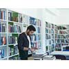 portrait of student in collage school library, arab youth learning and reading book