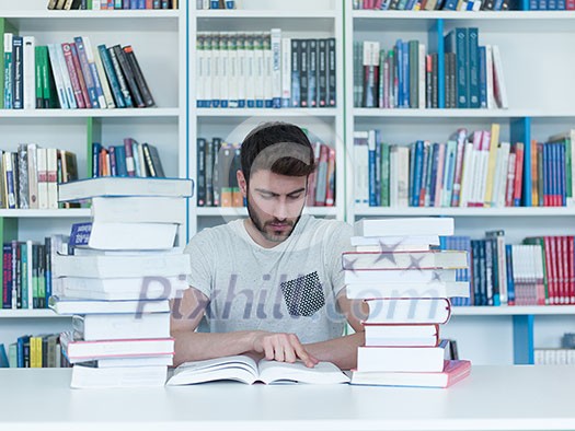 portrait of student in collage school library, arab youth learning and reading book portrait of student in collage school library, arab youth learning and reading book