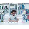 portrait of student in collage school library, arab youth learning and reading book