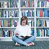 student girl  in collage school library reading book