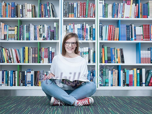 student girl in collage school library reading book student girl in collage school library reading book