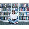 student girl  in collage school library reading book