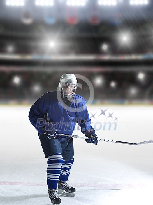 ice hockey player in action kicking with stick in front of big modern hockey arena with lights and flares ice hockey player in action kicking with stick in front of big modern hockey arena with lights and flares