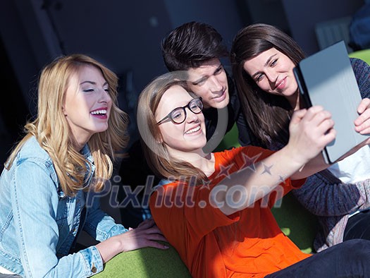 happy students group taking selfie with smartphone and tablet computer happy students group taking selfie with smartphone and tablet computer