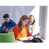 students group working on school  project  together on tablet computer  at modern university