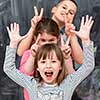 group portrait of happy childrens standing one behind the other while having fun in front of black chalkboard