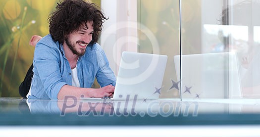 Real man Using laptop on the floor At Home Enjoying Relaxing Real man Using laptop on the floor At Home Enjoying Relaxing