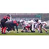 group of young professional american football players ready to start during training match on the stadium field