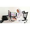 young afro american modern  muslim business woman wearing scarf on creative bright  office workplace with big screen