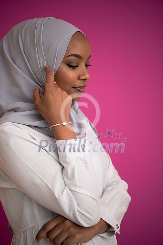 young afro beauty wearing traditional islamic clothes on plastic pink background young afro beauty wearing traditional islamic clothes on plastic pink background