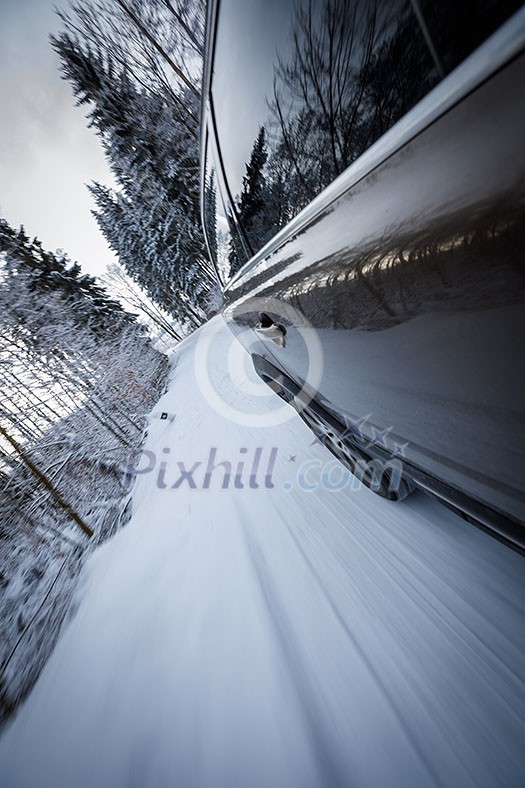 Fast moving car on a winter alpine snowy road Fast moving car on a winter alpine snowy road