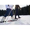 happy young  couple having fun and walking in snow shoes outdoor in nature at beautiful winter day. Health sport and relaxation