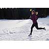 yougn woman jogging outdoor on snow in forest, healthy winter lifestyle and recreation