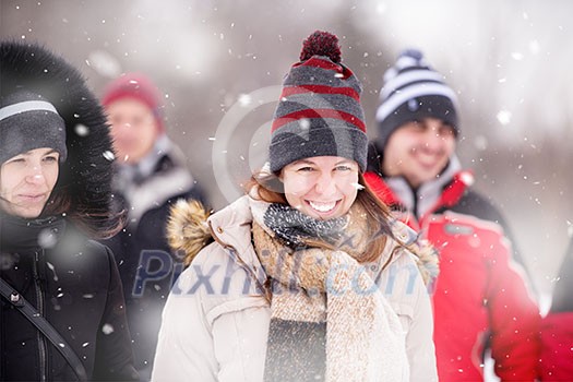 Woman in winter season Portrait of young woman in warm clothes enjoying snowy day with snowflakes around her in the winter forest Woman in winter season Portrait of young woman in warm clothes enjoying snowy day with snowflakes around her in the winter forest