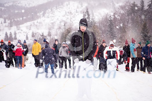 group of young happy business people having a running in bag competition while enjoying snowy winter day with snowflakes around them during a team building in the mountain forest group of young happy business people having a running in bag competition while enjoying snowy winter day with snowflakes around them during a team building in the mountain forest