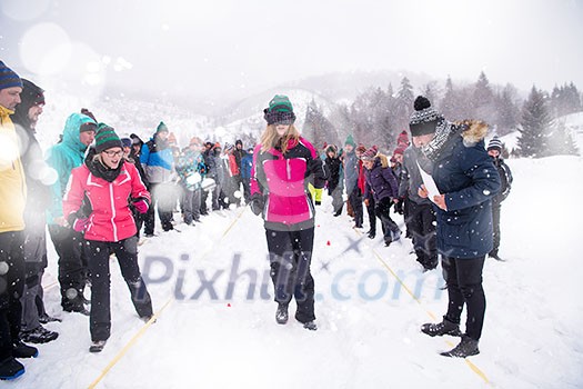 group of young happy business people having a Blindfolded games competition while enjoying snowy winter day with snowflakes around them during a team building in the mountain forest group of young happy business people having a Blindfolded games competition while enjoying snowy winter day with snowflakes around them during a team building in the mountain forest