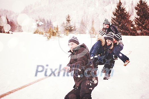 group of young happy business people pulling a rope in tug of war competition while enjoying snowy winter day with snowflakes around them during a team building in the mountain forest group of young happy business people pulling a rope in tug of war competition while enjoying snowy winter day with snowflakes around them during a team building in the mountain forest
