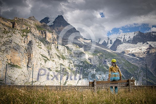 Pretty, female climber on a via ferrata - climbing on a rock in Swiss Alps Pretty, female climber on a via ferrata - climbing on a rock in Swiss Alps